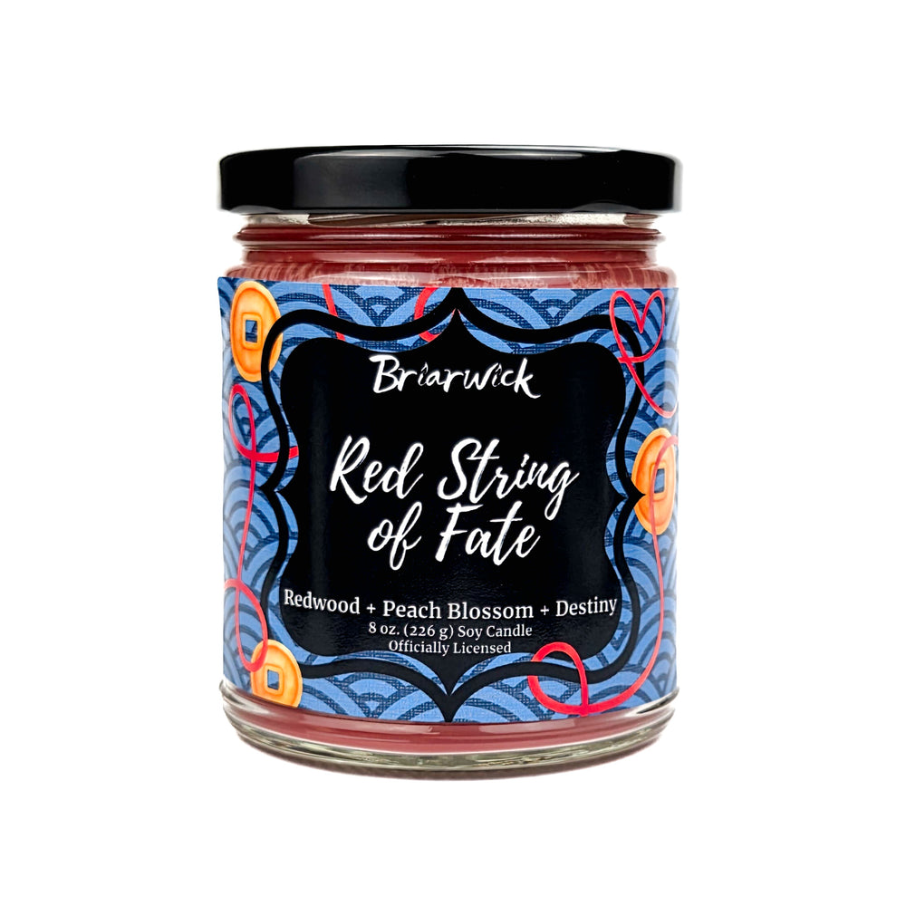 Jar of Briarwick Red String of Fate candle with decorative label on a white background