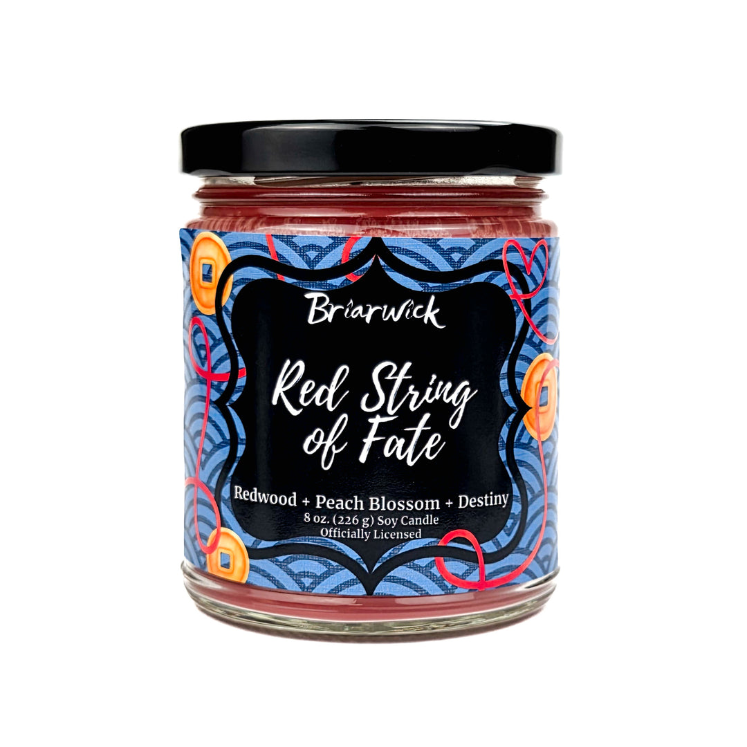 Jar of Briarwick Red String of Fate candle with decorative label on a white background