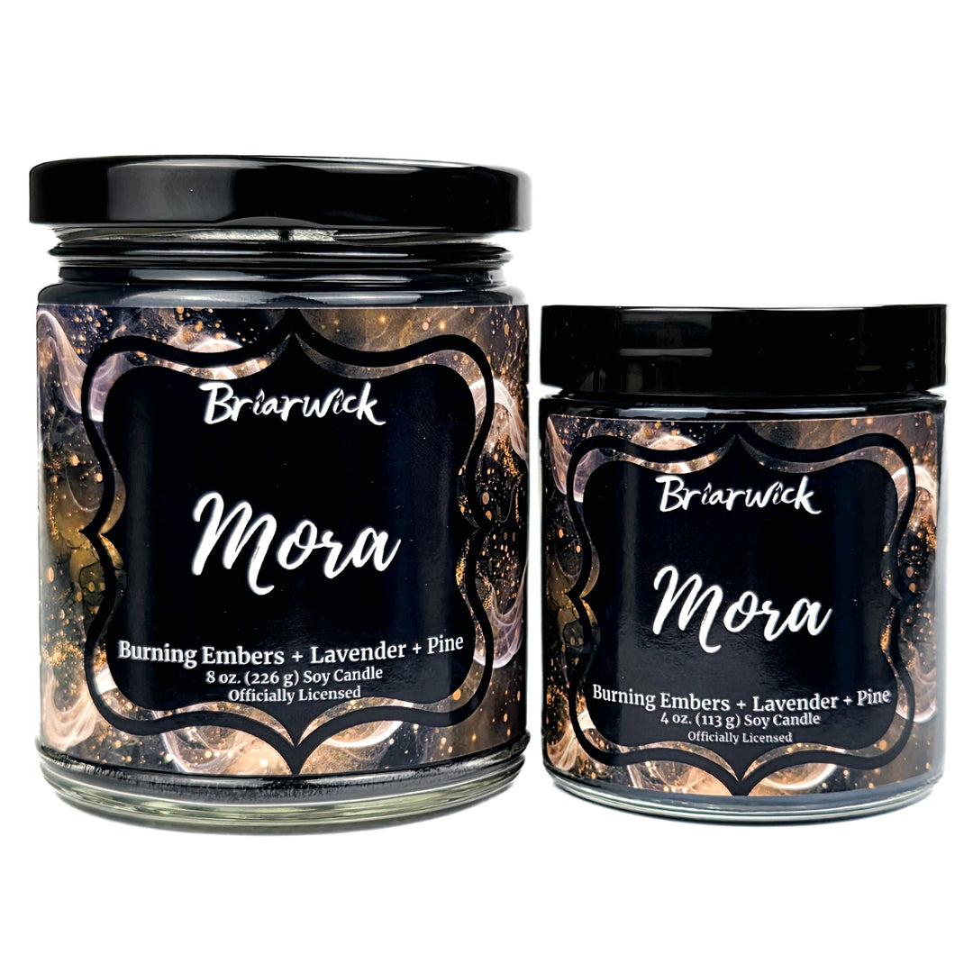 Two Briarwick Mora candles with black labels on a white background