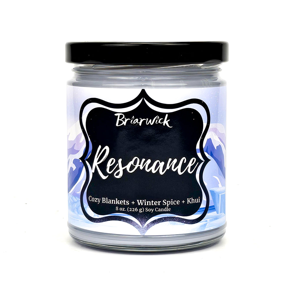 Resonance 8oz white candle with white mountain design on a white background