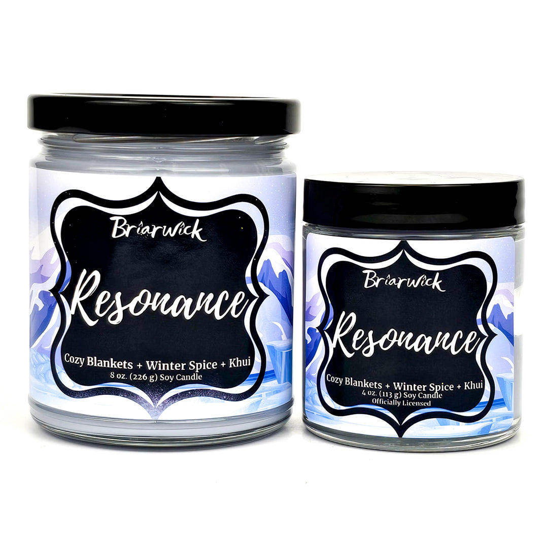 Resonance 8oz & 4oz white candles with white mountain designs on a white background