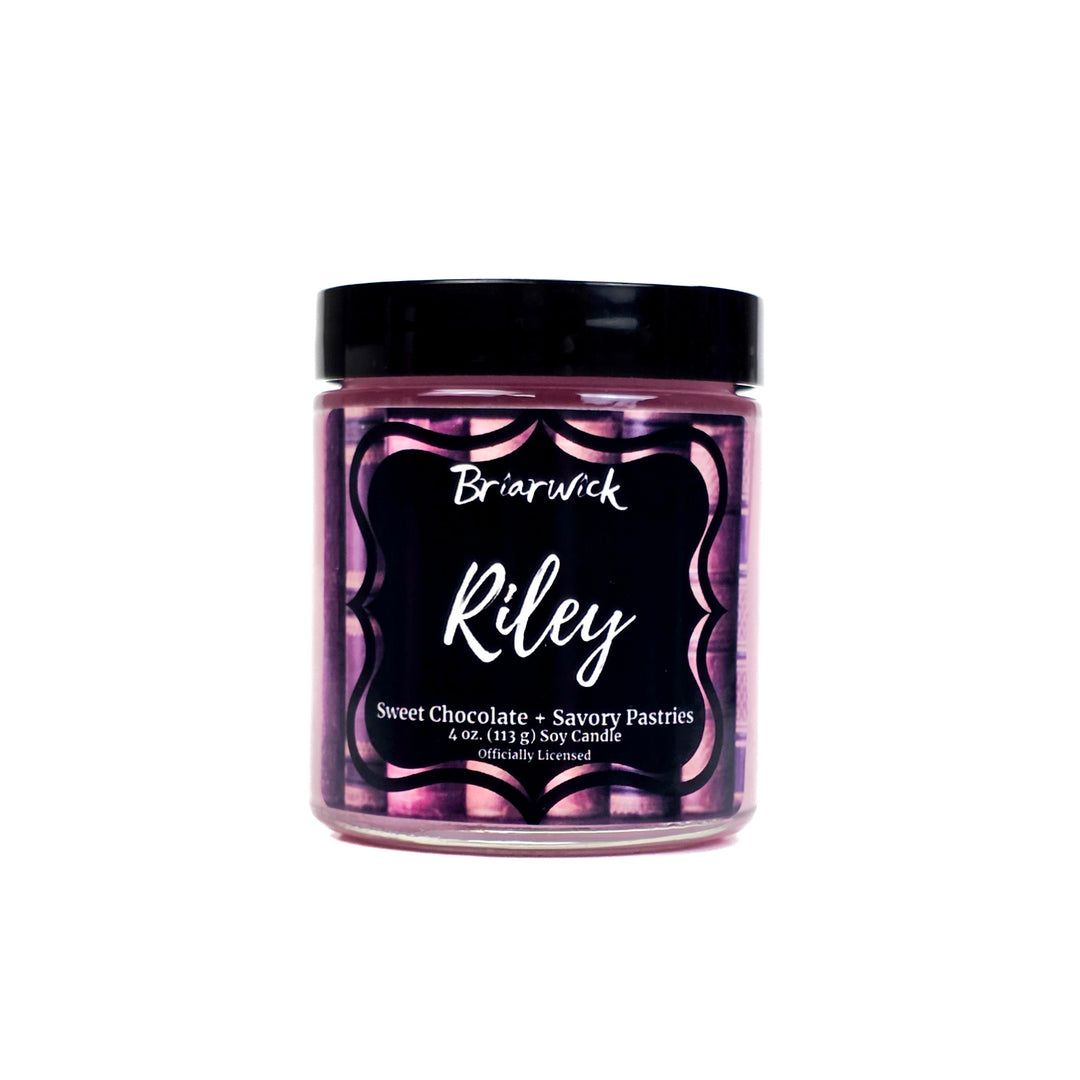 Briarwick 4oz candle in glass jar with pink label and scent name Riley on a white background