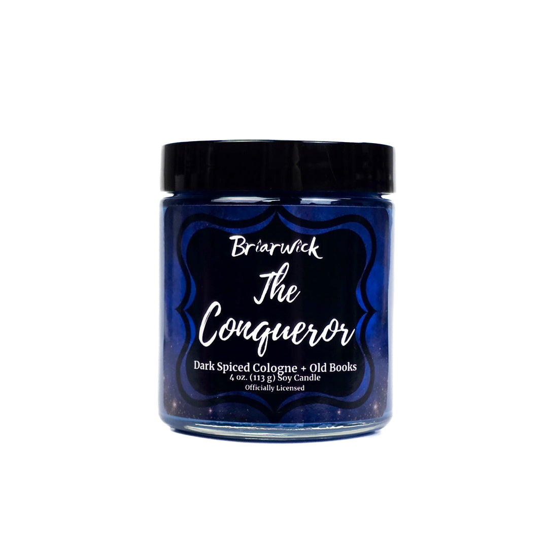 Blue 4oz candle labeled 'The Conqueror' by Briarwick on a white background
