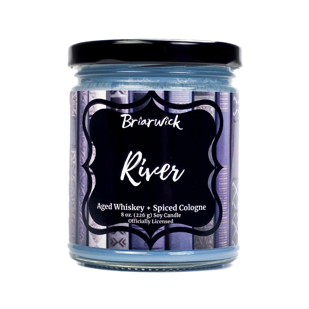 Jar of 'River' candle by Briarwick with a black lid on a white background