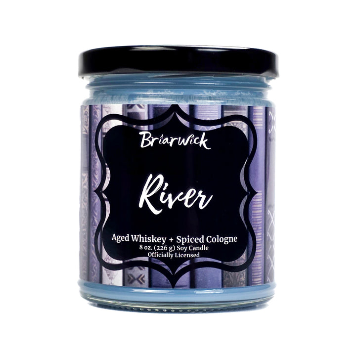 Jar of 'River' candle by Briarwick with a black lid on a white background