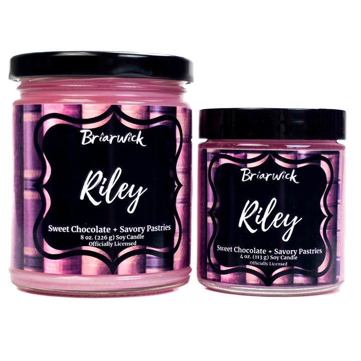 Two Briarwick Riley candles with pink labels on a white background
