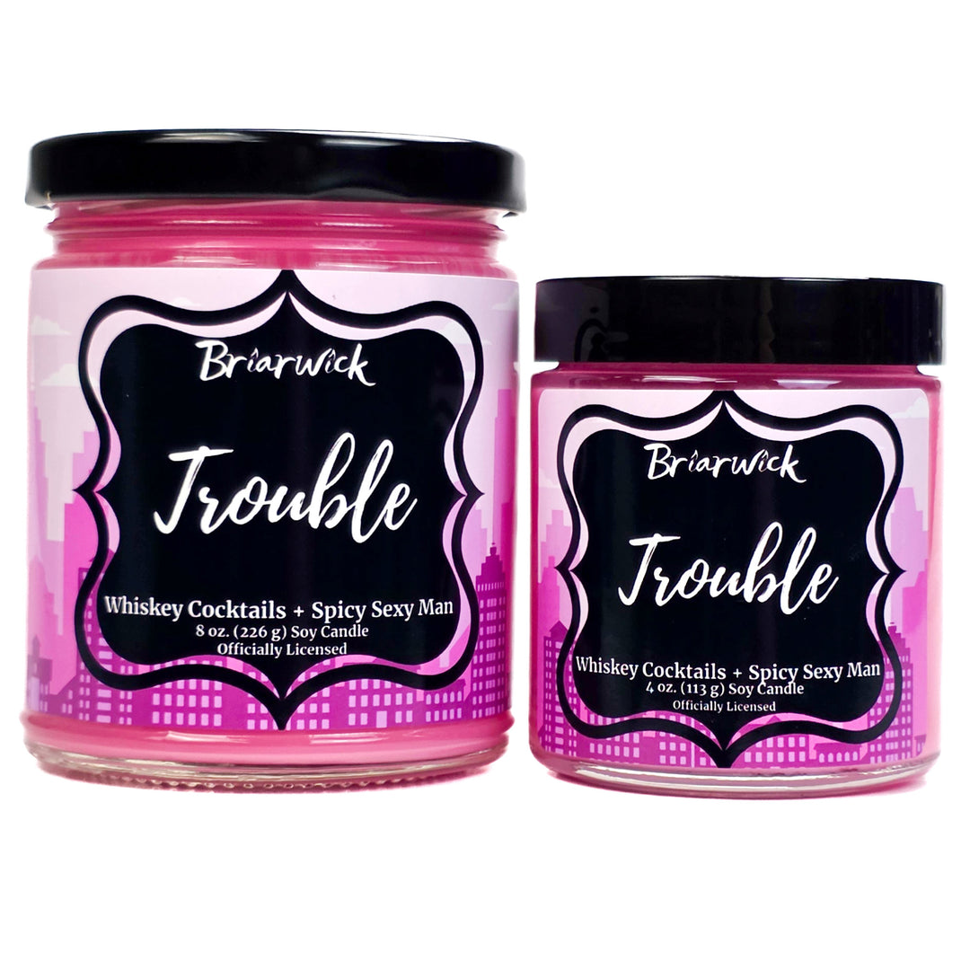 Two pink candles labeled 'Trouble' by Briarwick on a white background