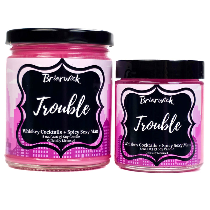 Two pink candles labeled 'Trouble' by Briarwick on a white background