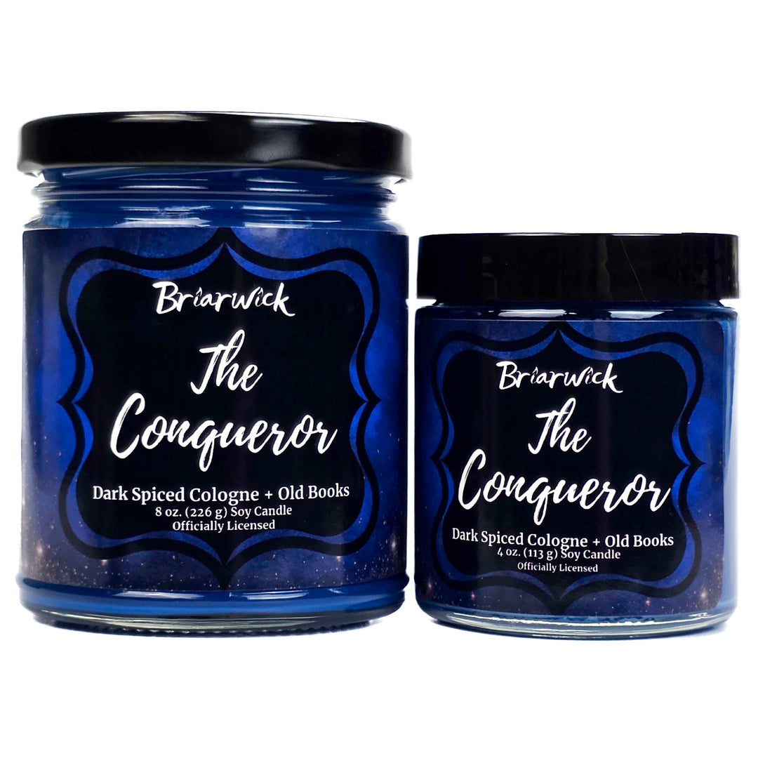 Two blue candle jars labeled 'The Conqueror' by Briarwick on a white background.