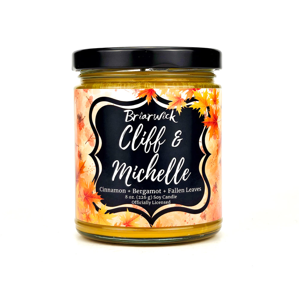 Cliffe & Michelle 8oz gold candle with yellow fall leaves design on a white background