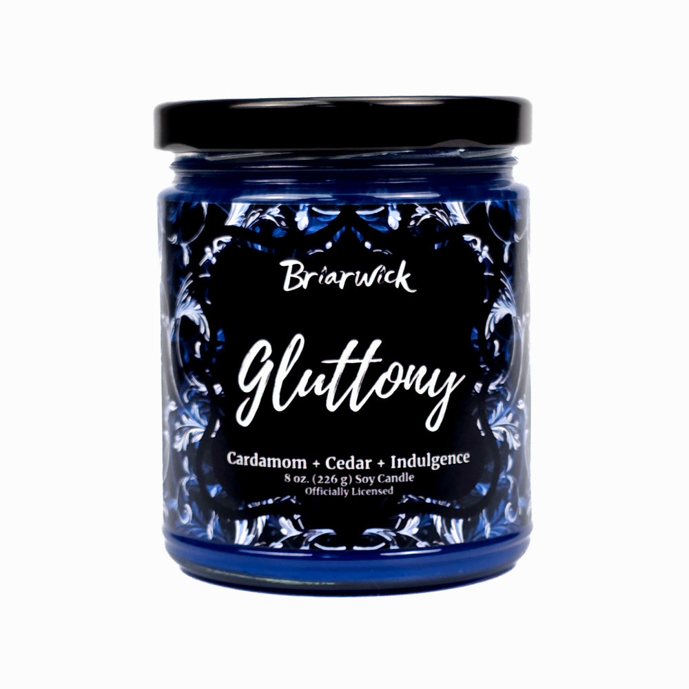 Gluttony 8oz blue candle with blue ornamental design on a white background