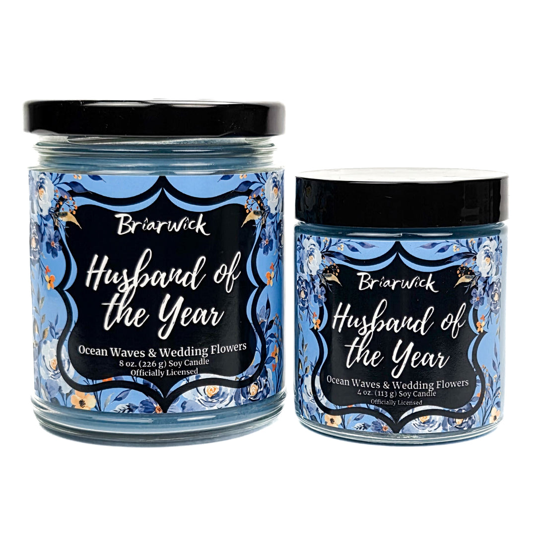 Blue Husband of the Year candles decorated with blue and white flowers on a white background. 