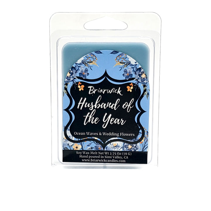 Blue Husband of the Year wax melt  decorated with blue and white flowers on a white background. 