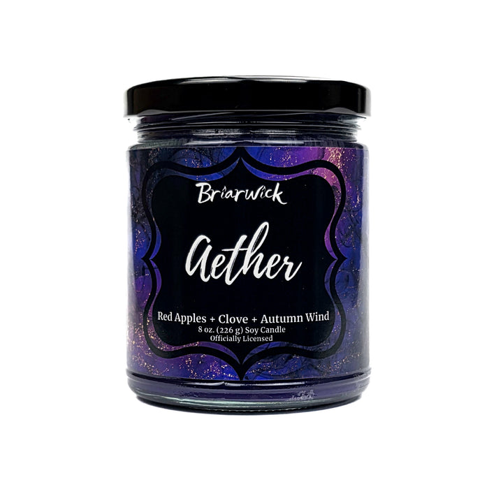 Aether 8oz deep purple candle with purple and gold marbled glitter label on a white background