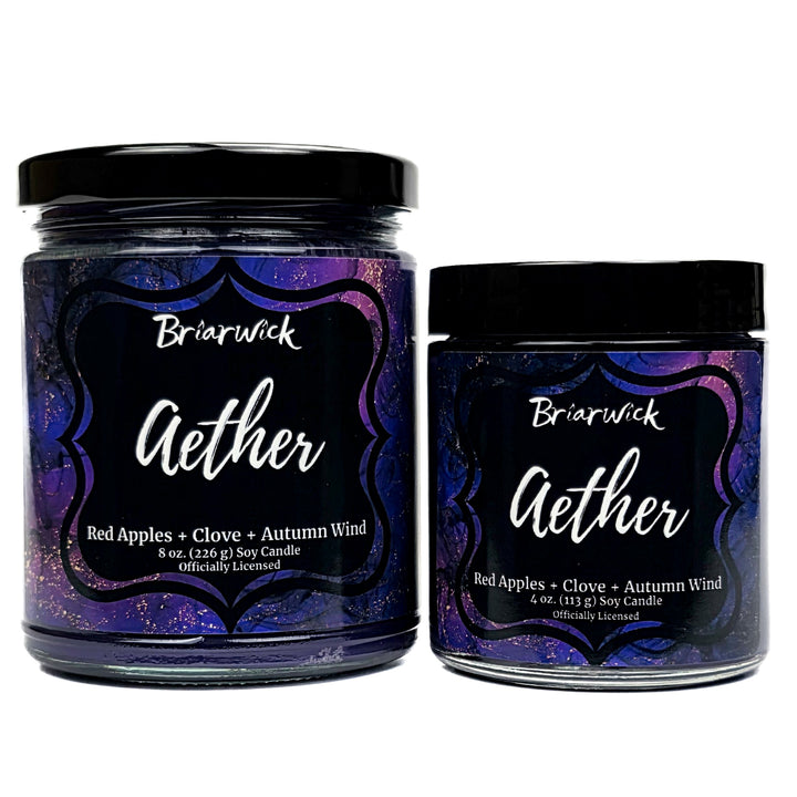 Aether 8oz & 4oz deep purple candle with purple and gold marbled glitter label on a white background