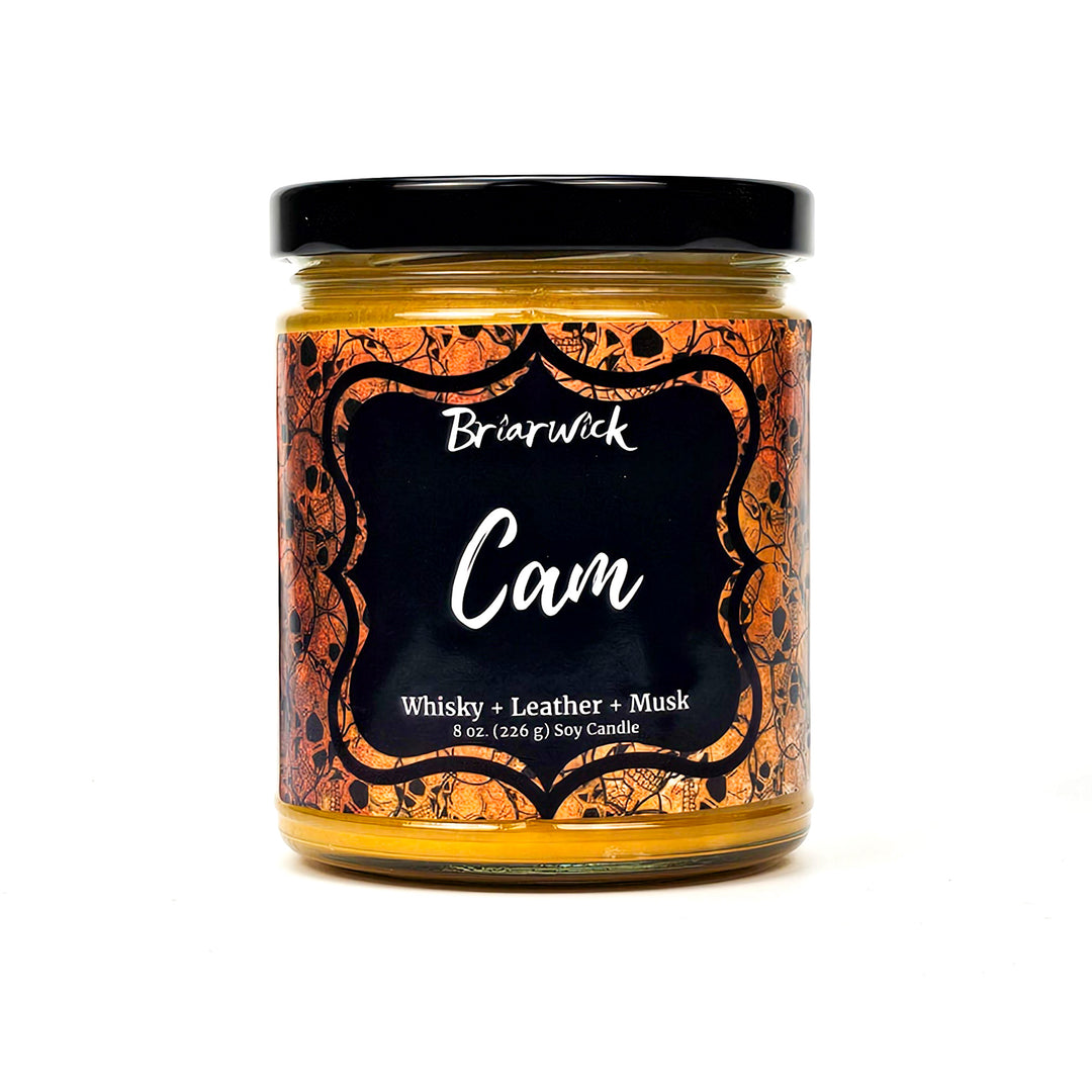 Cam 8oz gold candle with gold skull design on a white background