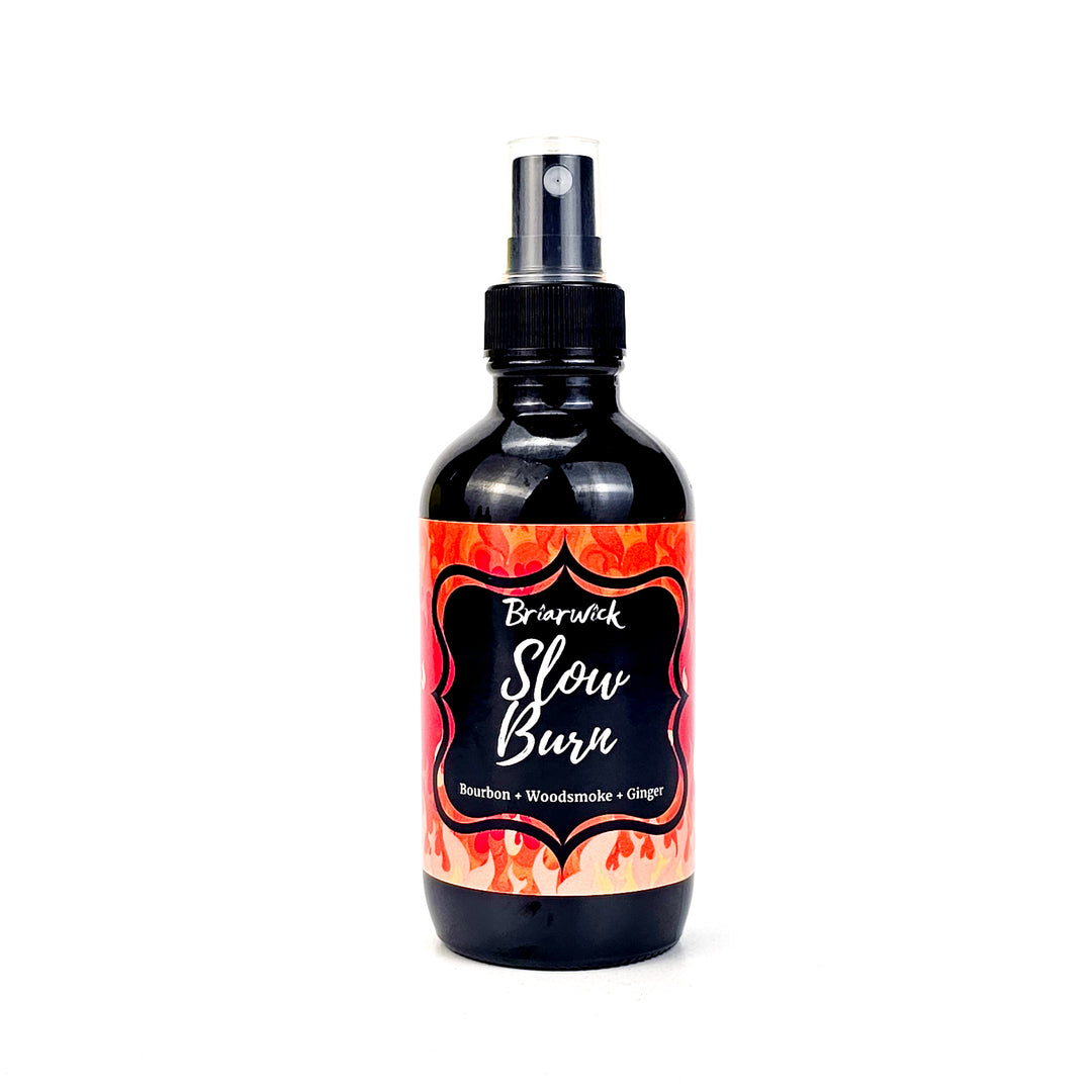 Slow Burn 4oz Linen Spray with orange flame design on a white background