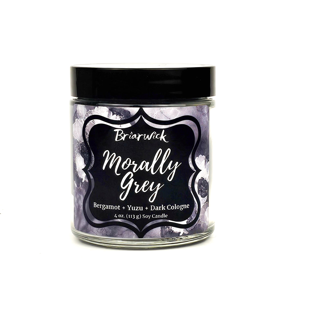 Morally Grey 4oz flint grey candle with grey floral design on a white background