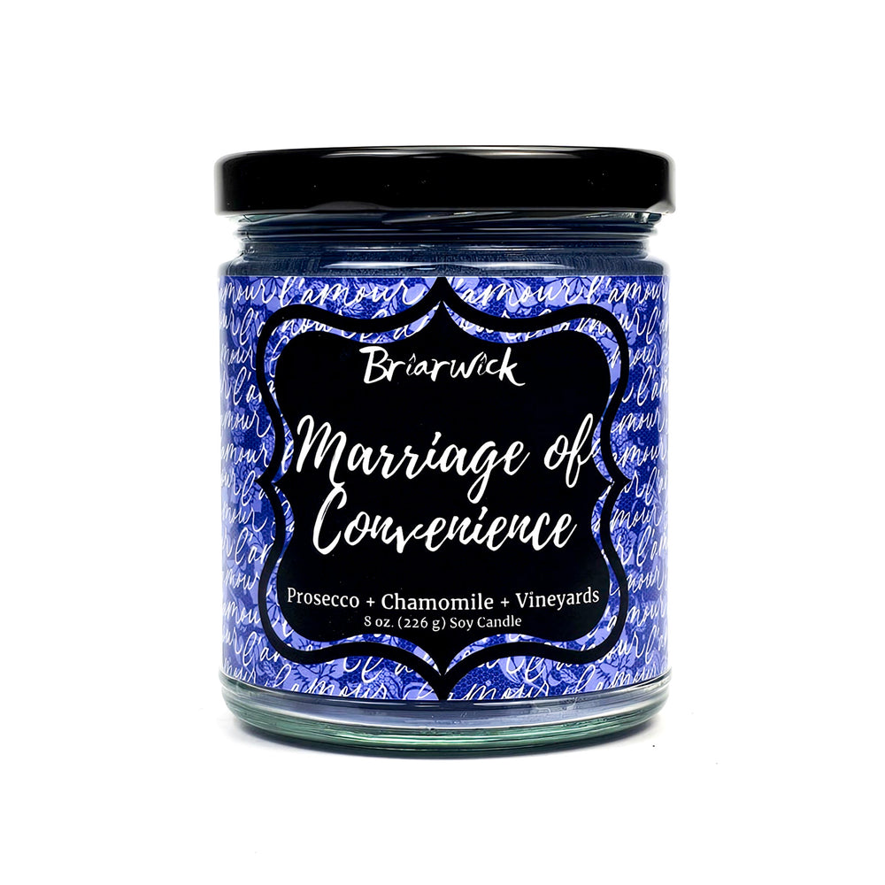 Marriage of Convenience 8oz purple candle with purple handwriting design on a white background