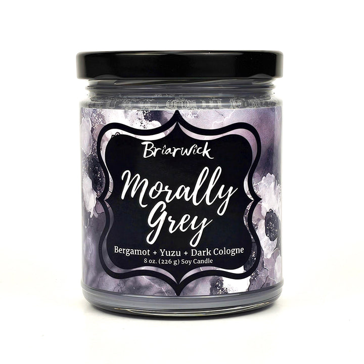Morally Grey 8oz flint grey candle with grey floral design on a white background
