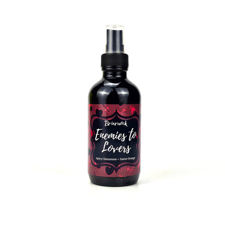 Enemies To Lovers 8oz red wine candle with red heart/sword design on a white background