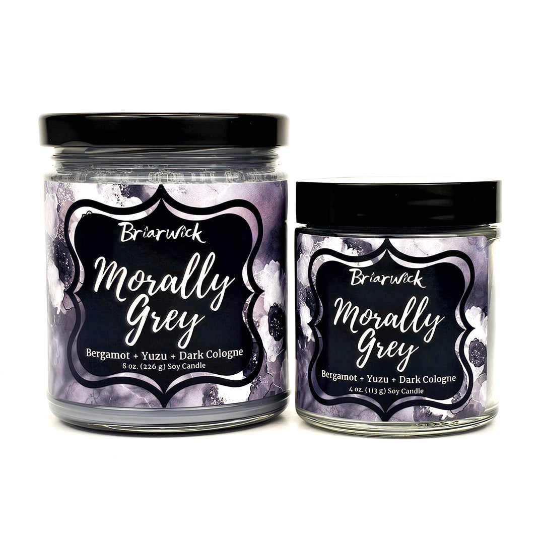 Morally Grey 8oz & 4oz flint grey candles with grey floral designs on a white background