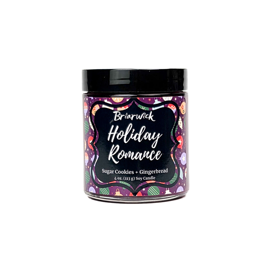 Holiday Romance 4oz colored candle with purple background and colorful ornament design on a white background