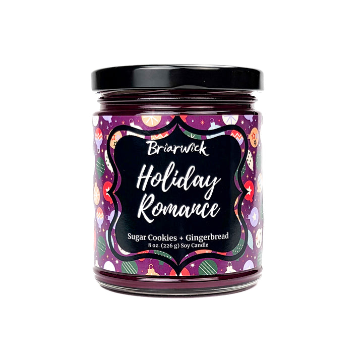 Holiday Romance 8oz colored candle with purple background and colorful ornament design on a white background