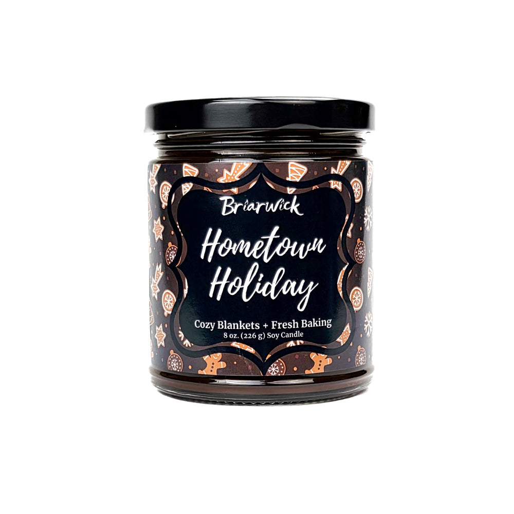 Briarwick Hometown Holiday 8oz candle with brown and white gingerbread design on a white background