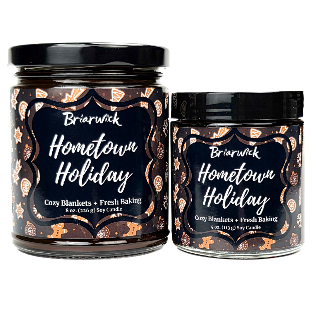 Hometown Holiday 8oz and 4oz colored candle with brown and white decorated gingerbread design on a white background