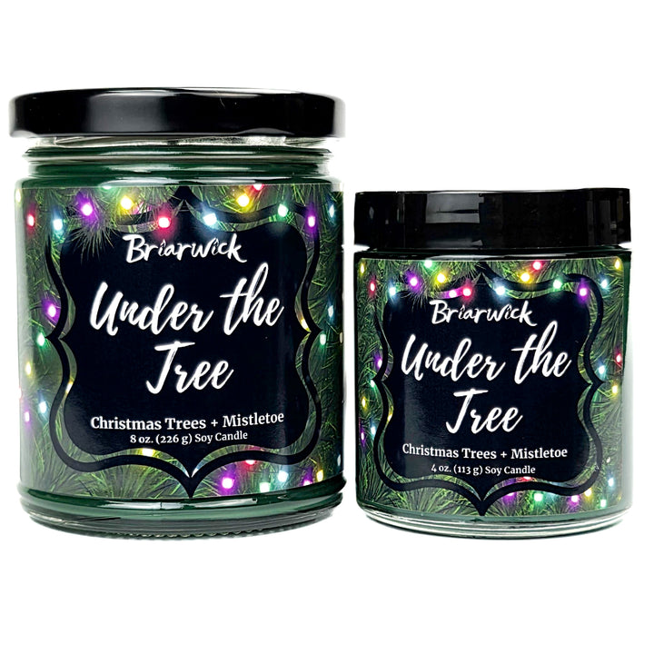 Under the Tree 8oz and 4oz colored candle with christmas tree and colorful lights design on a white background