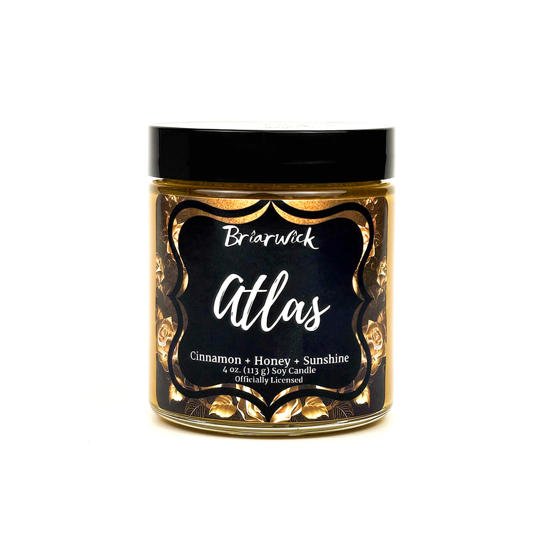 Atlas 4oz gold candle with gold floral design on a white background