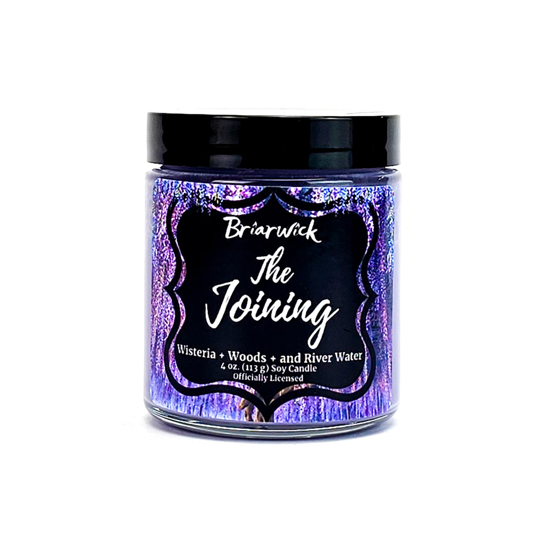 a jar of purple and black glitter with a black lid