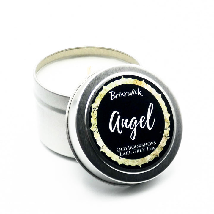 an open tin of angel candle sitting on a white surface
