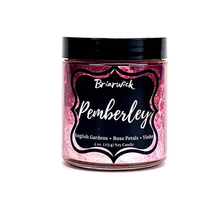a jar of pink glitter with a black lid