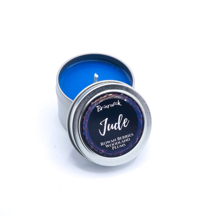 a small tin with a candle inside of it