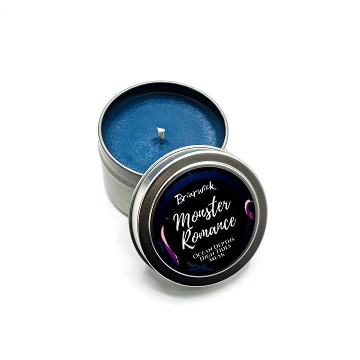 a blue tin with a candle inside of it