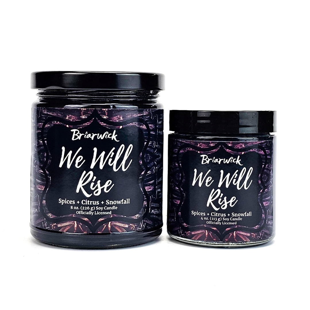 two jars of we will rise candles on a white background