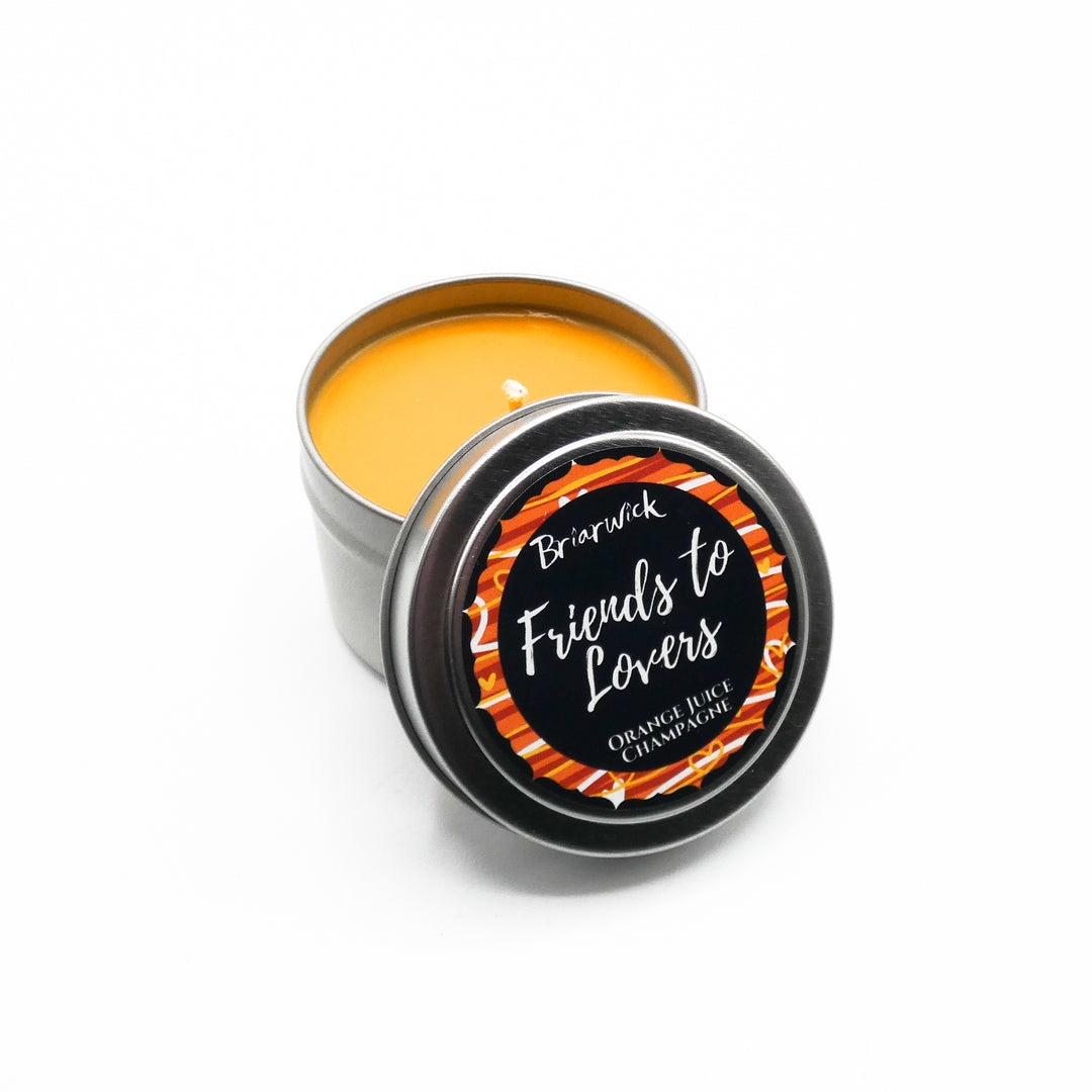 a tin of orange colored lip bale sitting on a white surface