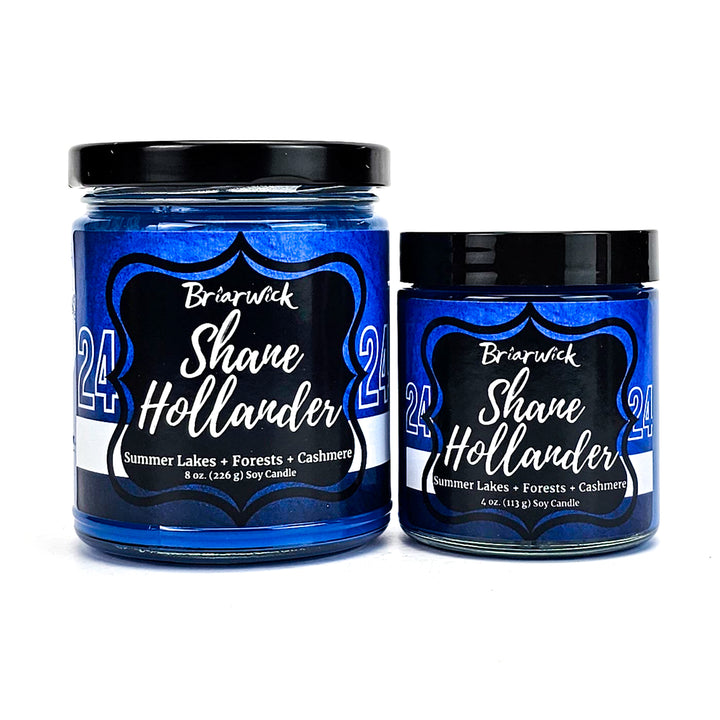 two jars of blue and black food on a white background