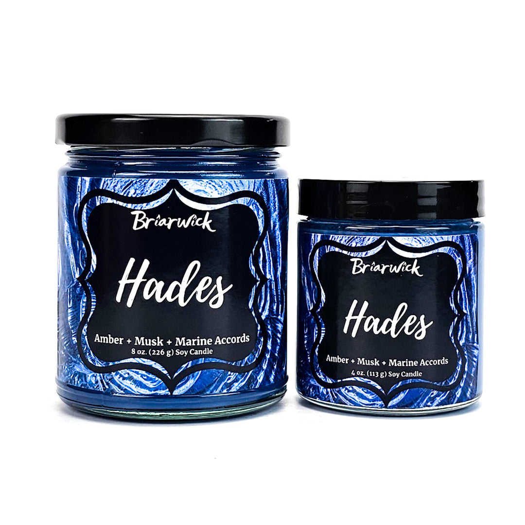 two jars of blue candles sitting next to each other