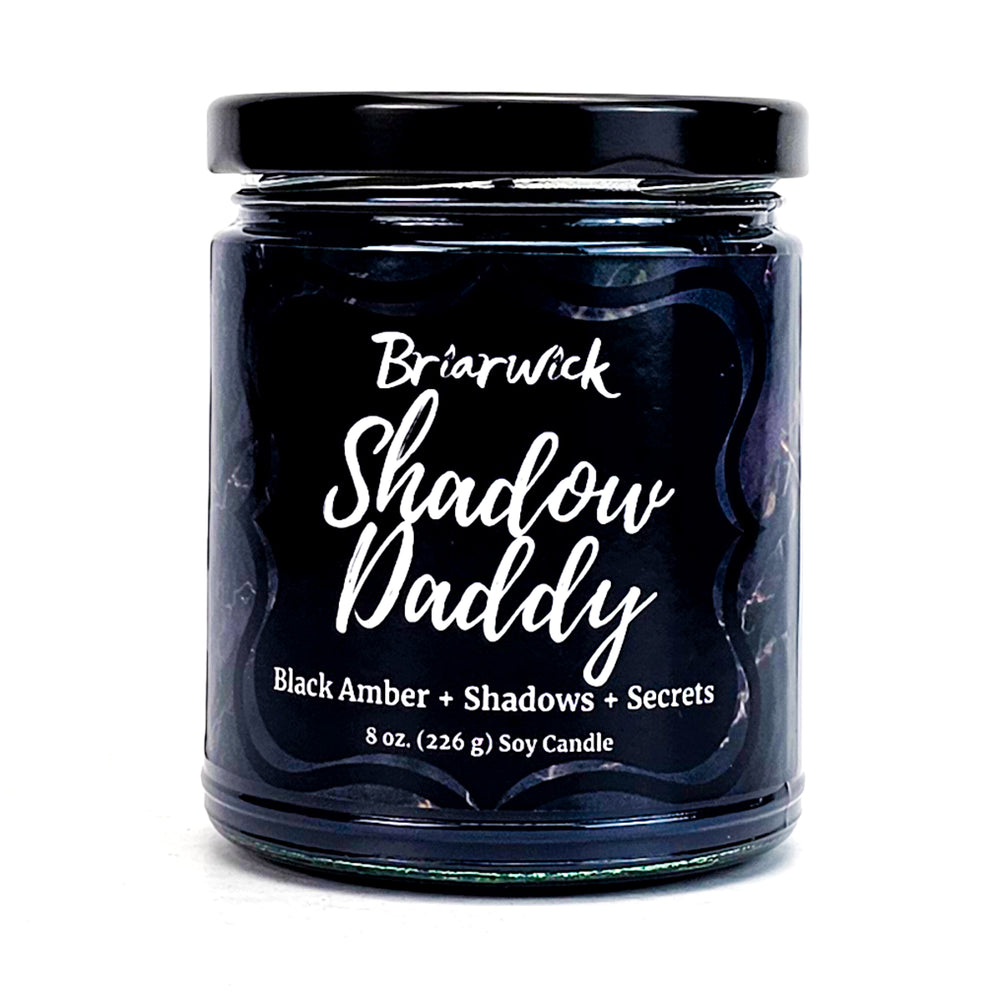 Shadow Daddy 8oz black candle with black textured design on a white background