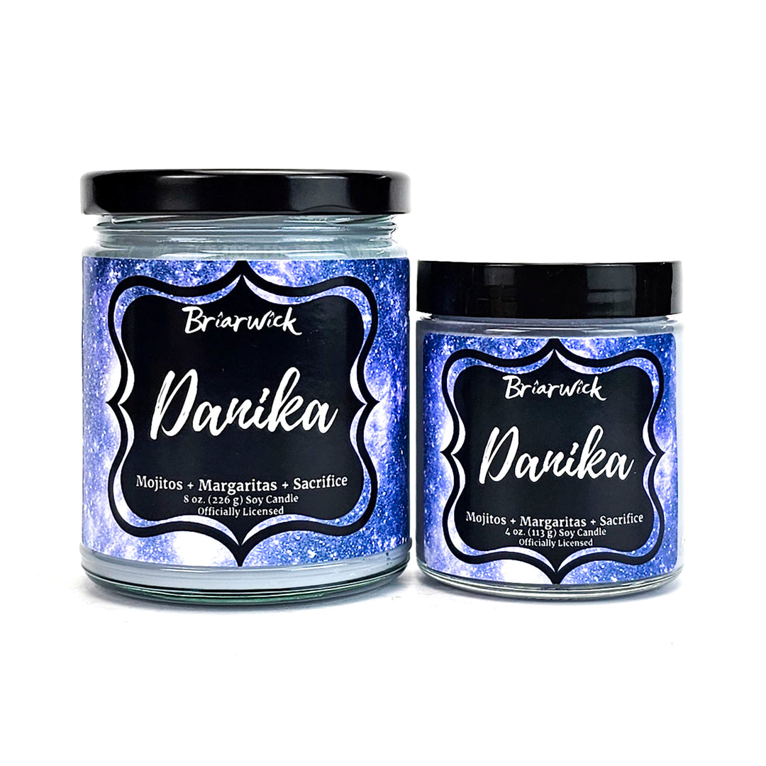 two jars of blue glitter with black lids