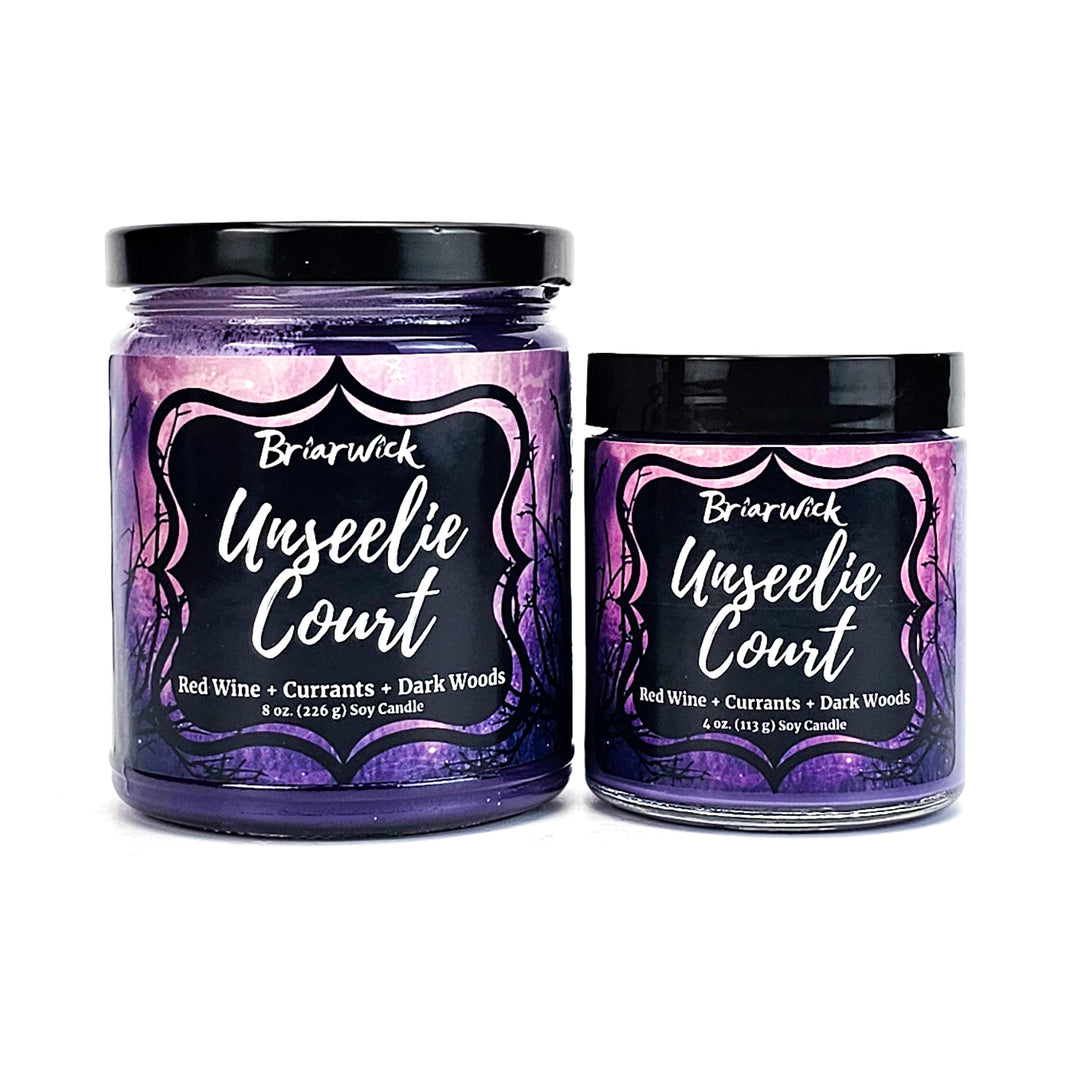 two jars of purple liquid with black lids