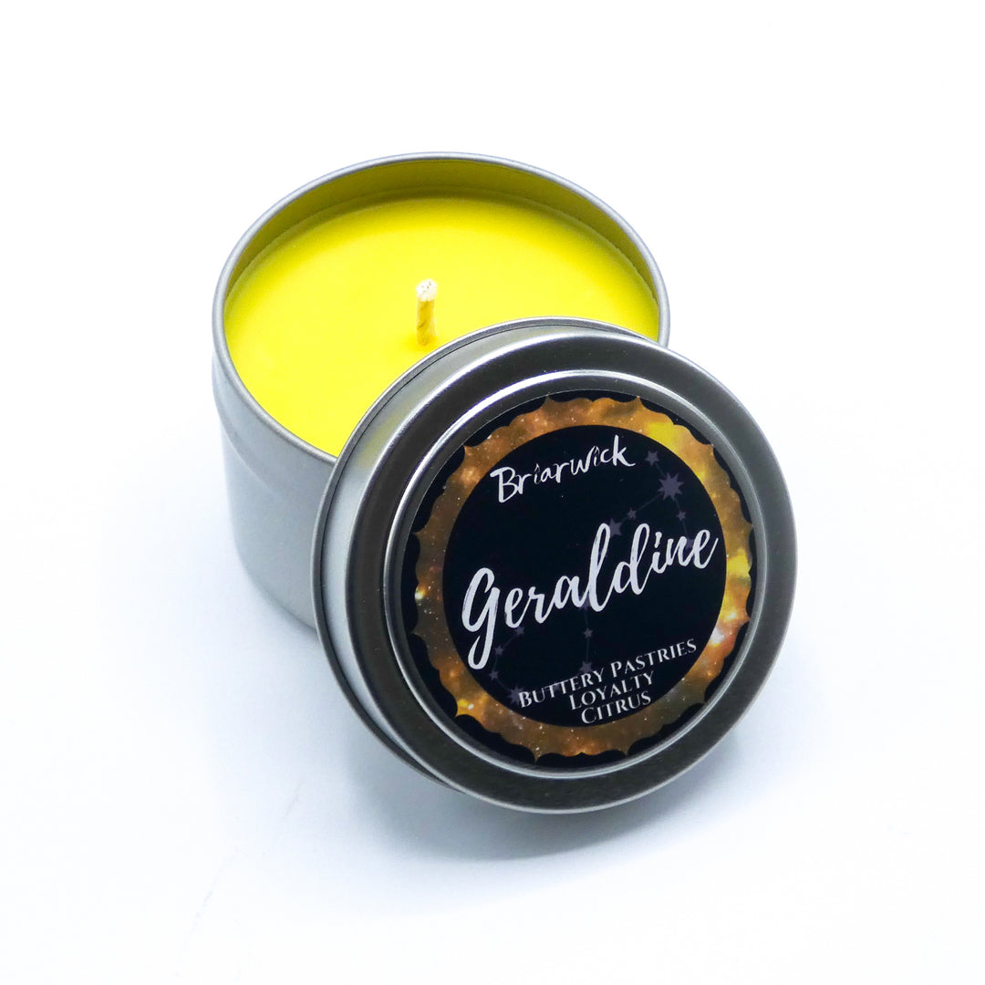 a small tin with a yellow candle inside of it