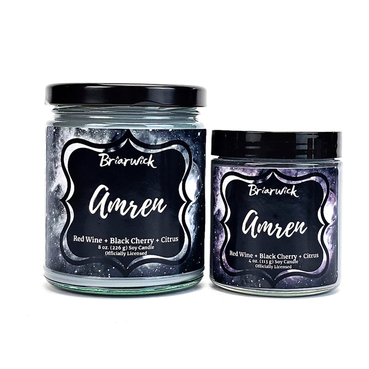 two jars of white and black candles on a white background