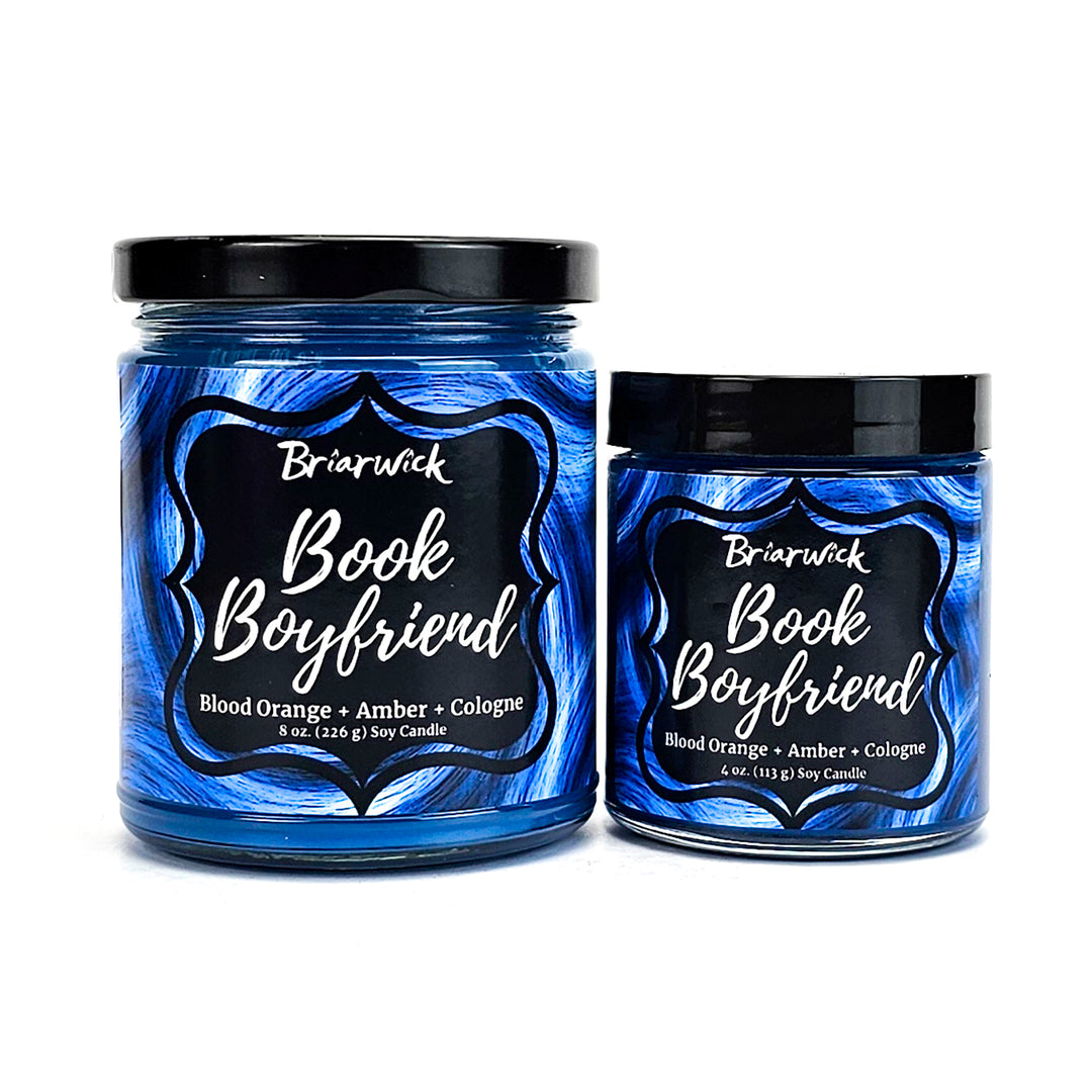 two jars of blue colored candles with black lids
