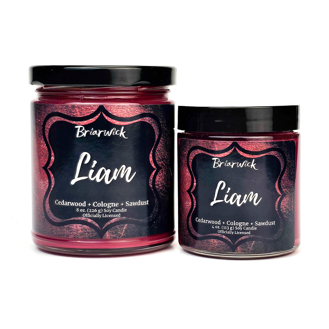 two jars of pink and black candles