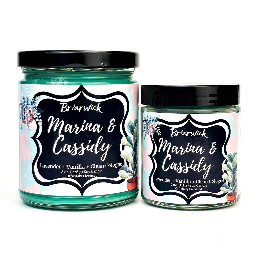 Marina & Cassidy 8oz blue green candle with pink/blue checker design on a white background