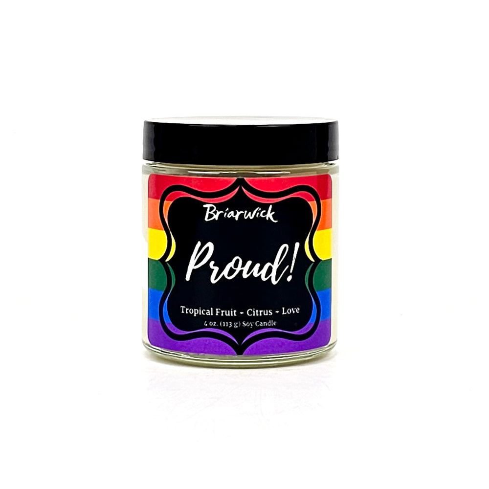PROUD! 4oz white candle with rainbow pride flag on a white background
